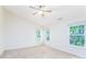 Spacious carpeted bedroom featuring a ceiling fan and two large windows at 162 Limerick Rd # C, Mooresville, NC 28115