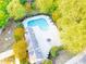 An aerial view reveals a community swimming pool surrounded by mature trees and seating areas at 162 Limerick Rd # C, Mooresville, NC 28115