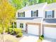 Well-maintained townhome boasting a one-car garage, manicured landscaping and tasteful stone accents at 162 Limerick Rd # C, Mooresville, NC 28115