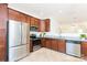 Well-lit kitchen with stainless steel appliances, granite countertops, and dark wood cabinets at 162 Limerick Rd # C, Mooresville, NC 28115