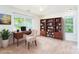 Office space with hardwood floors, a desk, chair, bookshelf, and a large plant at 162 Limerick Rd # C, Mooresville, NC 28115