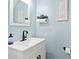 Stylish powder room featuring modern fixtures, a vanity with storage, and elegant decor at 164 Singleton Rd, Mooresville, NC 28117