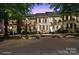 Charming brick townhomes featuring well-maintained landscaping and classic architectural details at twilight at 164 Singleton Rd, Mooresville, NC 28117