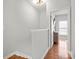 Second floor hallway with hardwood floors leading to bedroom with natural light at 164 Singleton Rd, Mooresville, NC 28117