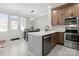 Modern kitchen with stainless steel appliances, quartz countertops, and a breakfast bar island at 164 Singleton Rd, Mooresville, NC 28117