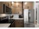 Close-up of kitchen featuring stainless steel appliances, wooden cabinets and quartz countertops at 164 Singleton Rd, Mooresville, NC 28117