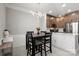 Open-concept kitchen and dining area with modern light fixture and wooden cabinets at 164 Singleton Rd, Mooresville, NC 28117