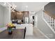 Open-concept kitchen and stairs with stainless appliances, undermount sink, and neutral paint at 164 Singleton Rd, Mooresville, NC 28117
