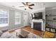 Charming living room featuring a fireplace, hardwood floors, and comfortable seating with natural light at 164 Singleton Rd, Mooresville, NC 28117