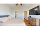 Comfortable main bedroom featuring a TV, ensuite bathroom, and adjacent staircase access at 164 Singleton Rd, Mooresville, NC 28117