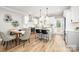 Eat-in kitchen featuring white cabinetry, stainless appliances, an island with breakfast bar, and dining area at 2003 Ashley Rd # A, Charlotte, NC 28208