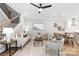 Bright living room with stairs, ceiling fan, neutral decor, and hardwood floors throughout at 2003 Ashley Rd # A, Charlotte, NC 28208