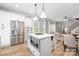 Bright kitchen features stainless steel appliances, white cabinetry, an island with breakfast bar, and an open concept design at 2003 Ashley Rd # B, Charlotte, NC 28208