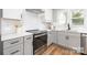Well-designed kitchen with stainless steel appliances, white countertops, and gray cabinets at 2003 Ashley Rd # B, Charlotte, NC 28208