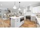 Open kitchen with stainless steel appliances, a center island with bar seating, and an adjacent living area at 2003 Ashley Rd # B, Charlotte, NC 28208