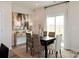 Dining area with a dark wood table, seating for six, a sideboard and a sliding door to the outside at 2104 Morgan Hill Dr, Albemarle, NC 28001