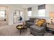 Cozy loft space with plush gray sofa, a work station, and natural light from the two windows at 2104 Morgan Hill Dr, Albemarle, NC 28001