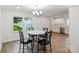 Well-lit dining area next to the kitchen with stylish black chairs around a table, great for gatherings at 2416 Wendy Ln # 13, Gastonia, NC 28052