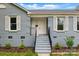 Charming blue painted brick home with a welcoming front entrance and well-manicured landscaping at 2416 Wendy Ln # 13, Gastonia, NC 28052