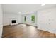 Bright living room featuring a classic fireplace, hardwood floors, and natural light for a cozy feel at 2416 Wendy Ln # 13, Gastonia, NC 28052