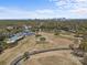 Aerial view of a golf course and pool with city skyline in the distance at 2637 Normandy Rd, Charlotte, NC 28209