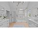 Bathroom with glass shower, dual vanities, and modern lighting at 2637 Normandy Rd, Charlotte, NC 28209