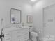 Bright bathroom featuring a vanity with drawers, modern fixtures, and a glass enclosed shower at 2637 Normandy Rd, Charlotte, NC 28209