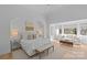 Bright bedroom features neutral palette, sitting area by the window, and hardwood floors at 2637 Normandy Rd, Charlotte, NC 28209