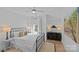 Cozy bedroom with a large bed, ceiling fan, and natural light from the window at 2637 Normandy Rd, Charlotte, NC 28209