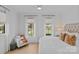Light-filled bedroom featuring a neutral palette, large windows, and comfortable seating area at 2637 Normandy Rd, Charlotte, NC 28209