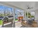 Covered outdoor deck with lounge seating, a grill, and overhead fan at 2637 Normandy Rd, Charlotte, NC 28209