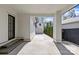 View of the driveway leading to a two-car garage with trimmed bushes along the side at 2637 Normandy Rd, Charlotte, NC 28209