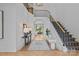 Bright foyer with hardwood floors, statement staircase, and view into living area at 2637 Normandy Rd, Charlotte, NC 28209