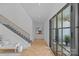 Grand foyer showcasing herringbone floors, staircase, and lots of natural light from a large glass door at 2637 Normandy Rd, Charlotte, NC 28209