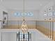 Bright foyer with modern chandelier, black railings, and transom windows offering natural light at 2637 Normandy Rd, Charlotte, NC 28209