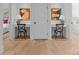 Hallway featuring dual built-in desks, stylish chairs, and modern art at 2637 Normandy Rd, Charlotte, NC 28209