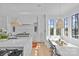 Elegant, bright kitchen with an island, bar seating, built-in breakfast nook, and modern fixtures at 2637 Normandy Rd, Charlotte, NC 28209