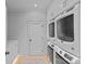 Laundry room with new stacked washer/dryer units and ample storage at 2637 Normandy Rd, Charlotte, NC 28209