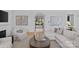Cozy living room with neutral tones, fireplace, and view into manicured outdoor space at 2637 Normandy Rd, Charlotte, NC 28209