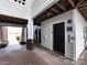Exterior passenger elevator with adjacent stairwell, surrounded by brick pavers and lush landscaping at 2719 Selwyn Ave # 3, Charlotte, NC 28209