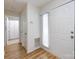 A bright entryway with hardwood flooring, a white door, and access to the bathroom at 2719 Selwyn Ave # 3, Charlotte, NC 28209