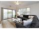 Cozy living room featuring a plush gray sectional sofa, white coffee table, and sliding glass doors to the balcony at 2719 Selwyn Ave # 3, Charlotte, NC 28209