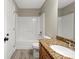 Functional bathroom with a combined shower-tub, wood-style floor tiles, and a granite vanity at 2840 Wheatfield Ct, Lincolnton, NC 28092