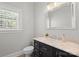 Well-lit half-bathroom with a modern vanity, marble countertop, decorative mirror and wooden floors at 2840 Wheatfield Ct, Lincolnton, NC 28092
