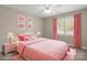 Charming pink bedroom featuring a comfortable bed, coordinating decor, and a window for natural light at 2840 Wheatfield Ct, Lincolnton, NC 28092