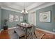 Elegant dining area features modern chandelier, decorative artwork, and a view to a separate doorway at 2840 Wheatfield Ct, Lincolnton, NC 28092