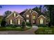 Stunning brick home with manicured lawn, lush landscaping, and a winding walkway to the front door at 2840 Wheatfield Ct, Lincolnton, NC 28092