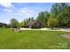 Expansive lawn surrounds this elegant brick home, set back from the road and framed by mature trees at 2840 Wheatfield Ct, Lincolnton, NC 28092