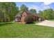 Side view of a brick home with a large manicured lawn and mature trees at 2840 Wheatfield Ct, Lincolnton, NC 28092