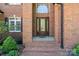Elegant brick entryway features a beautiful wood door with decorative glass, creating a welcoming entrance at 2840 Wheatfield Ct, Lincolnton, NC 28092